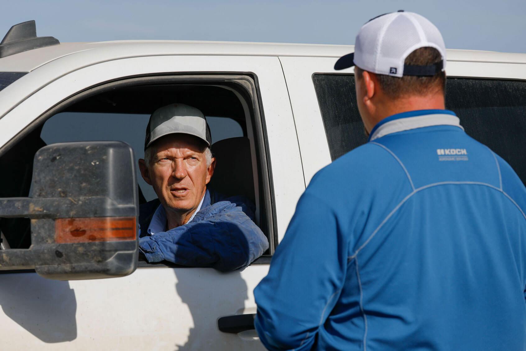 Guys talking by truck